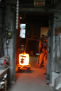 Preparing two tons of molten bronze for casting the memorial wall, 2006