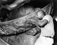 A painter from DC 9 refurbishes a statue at Rockefeller Center in 1974